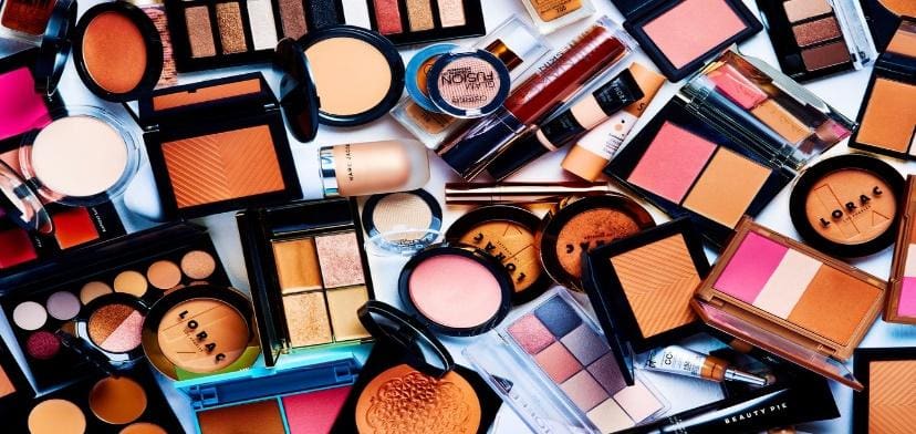 Assorted makeup products on white background.